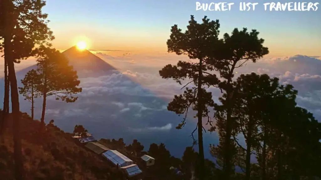 View of campground on Acatenango Volcano, Sun rising over Pacaya Volcano Guatemala, clouds surrounding Pacaya Volcano