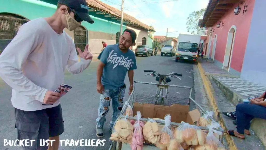 Man buying bread from street vendor in Granada Nicaragua