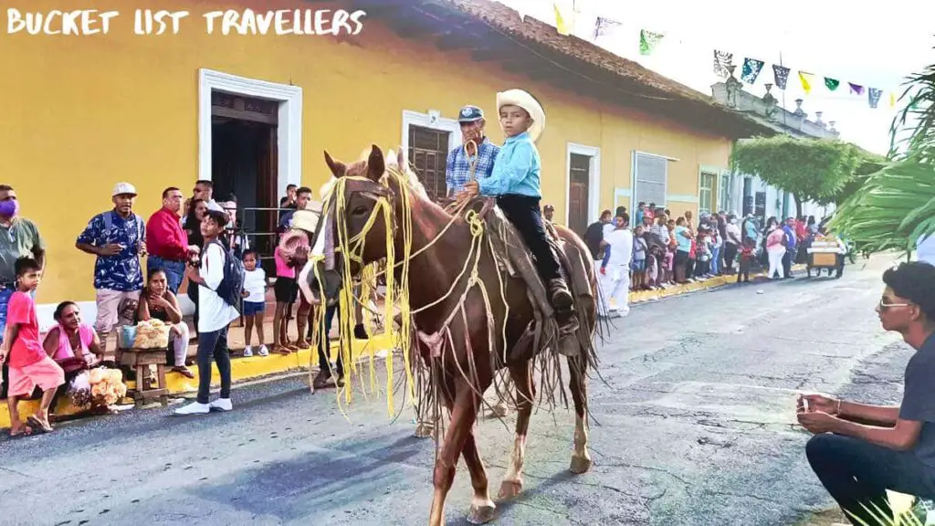 Young boy riding a horse at the Hipica Horse Riding Festival on Calle Real Xalteva Granada Nicaragua