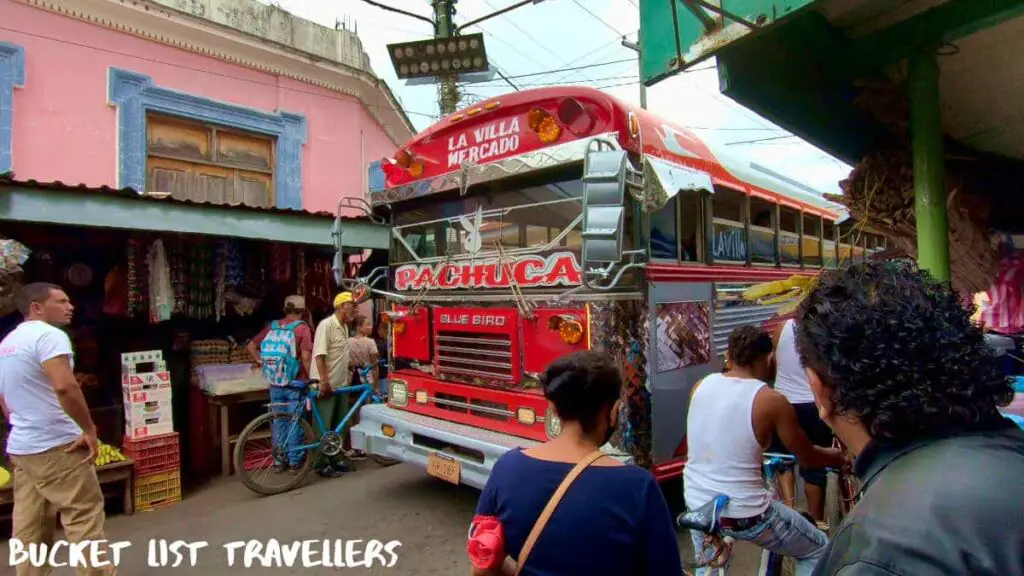 Local bus driving through Mercado Municipal de Granada Nicaragua