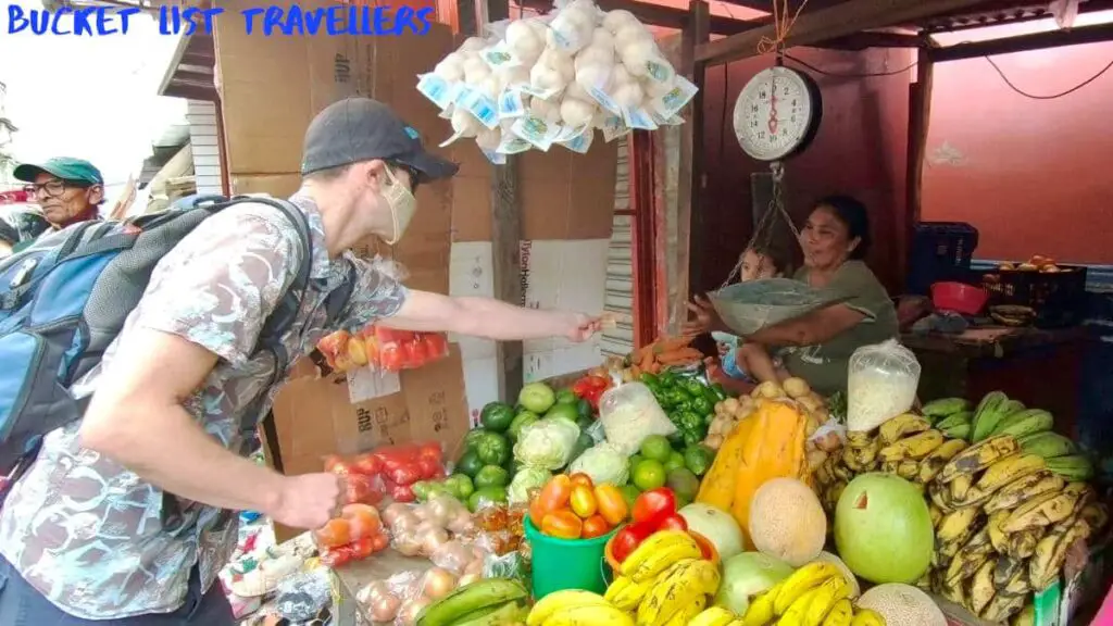 Man buying tomatoes at Mercado Municipal Granada Nicaragua