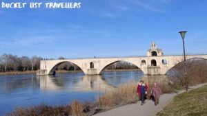 2 women walking along the Rhône River near Pont d'Avignon France