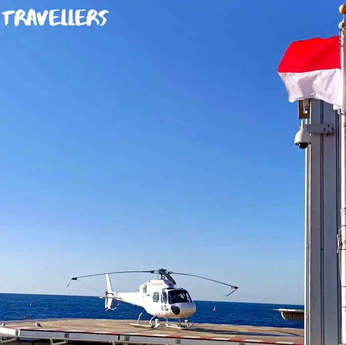 Helicopter at Monaco Heliport, Monaco Flag, red and white flag, Mediterranean Sea in background