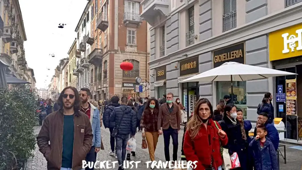 People walking down pedestrian street in Chinatown Milan Italy