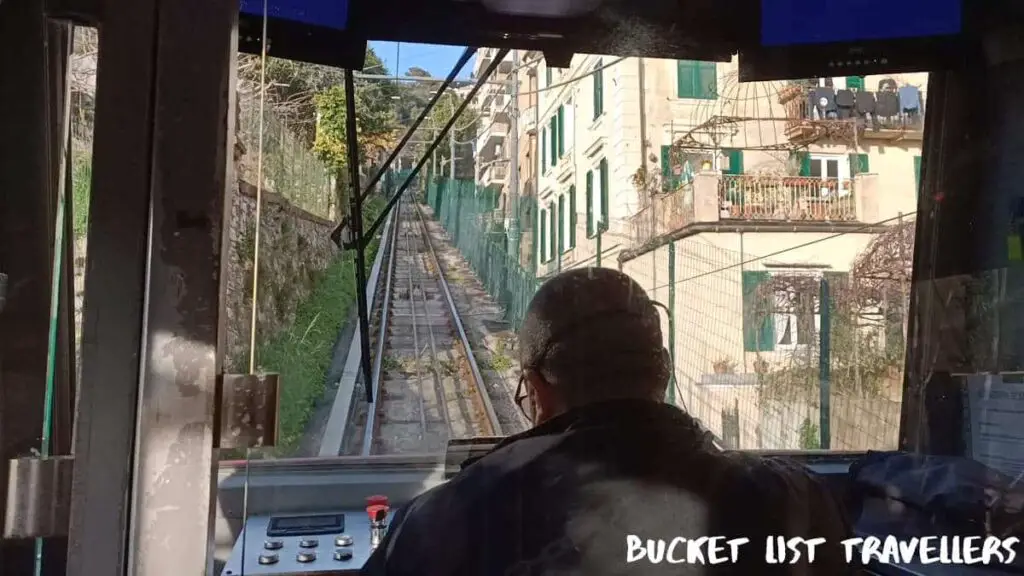 Funicular driver making the ascent up the tracks on Funicolare Zecca-Righi - Capolinea Largo Zecca Genoa Italy