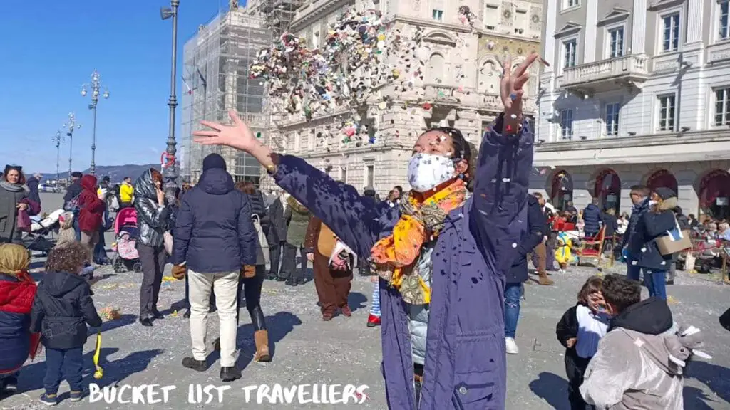 Throwing Confetti during Carnival at Piazza Unità d'Italia Trieste Italy
