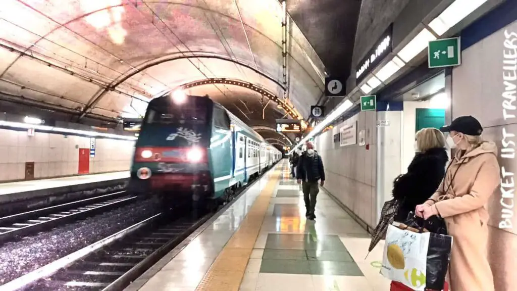 Trenitalia Train from Sanremo to Genoa Underground Train Platform Italy, people waiting on underground platform as train arrives