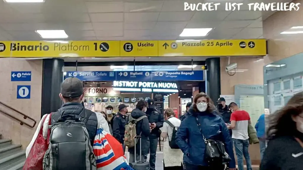 Inside Verona Porta Nuova Train Station Verona Italy, people wearing masks, transit police