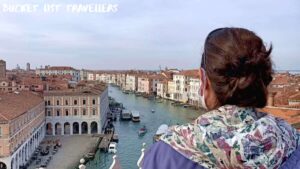 View over woman's shoulder at T Fondaco Rooftop Terrace Venice Italy