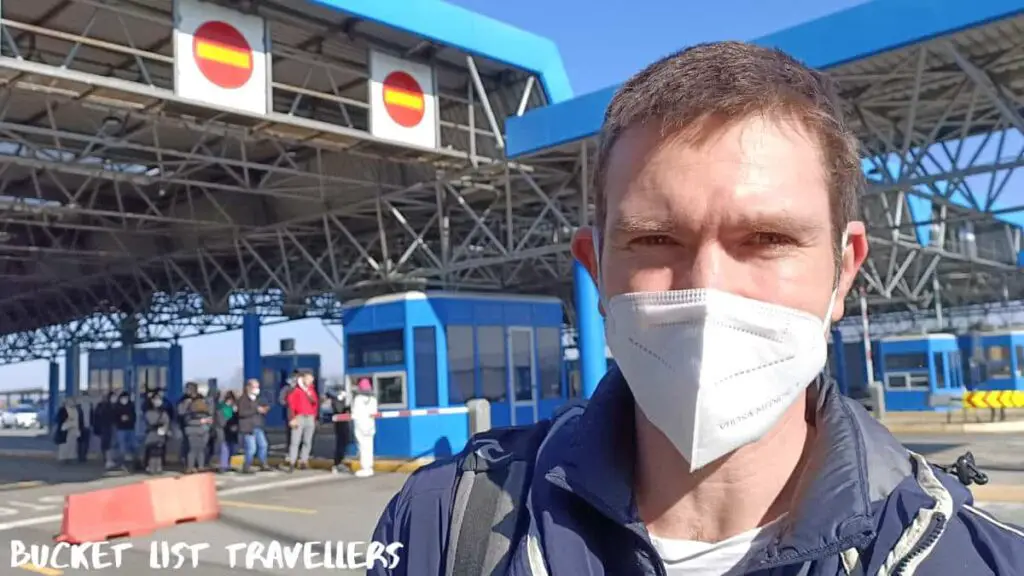 Croatia Border Crossing, man wearing mask in front of Croatian border