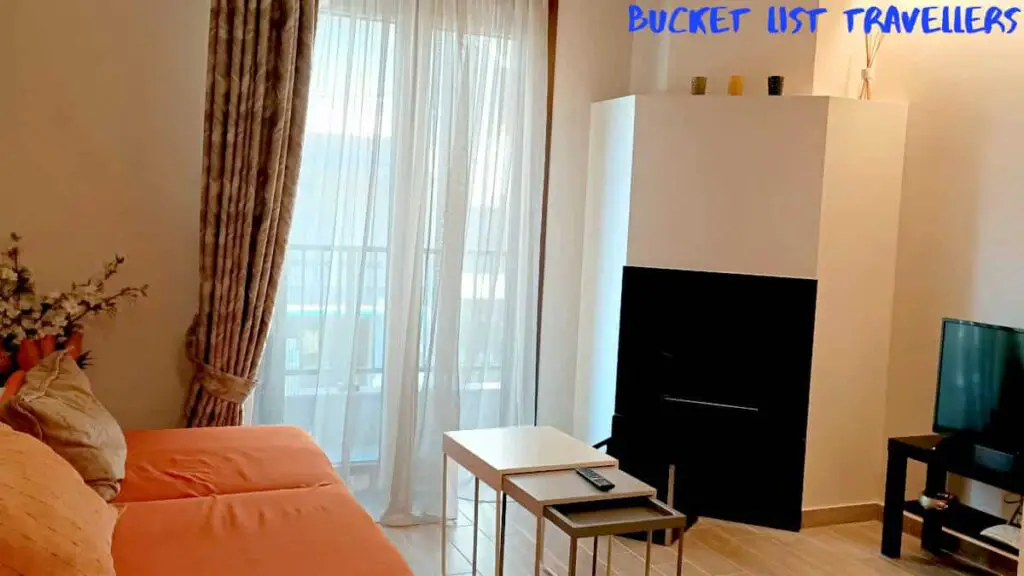 Airbnb Ioannina Greece, loungeroom, television and orange couch