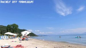 Row of white beach umbrellas at Moraitika Beach Corfu Greece