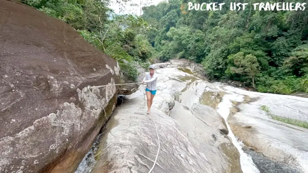Woman climbing up to Jelawang Waterfall Dabong
