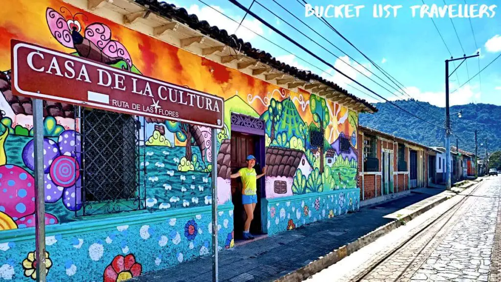 Woman standing in front of Mural at Apaneca on Ruta de las Flores El Salvador