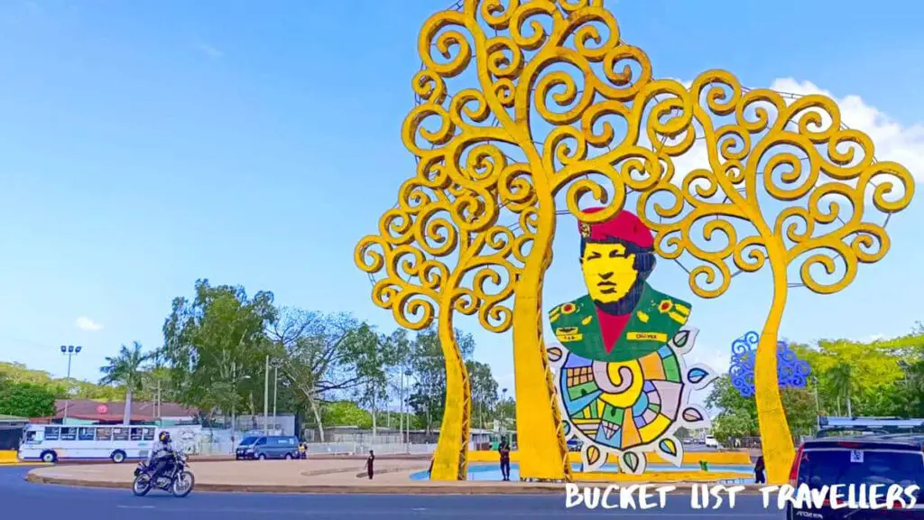 Roundabout with yellow Trees of Life and statue of Hugo Chavez at Rotonda Hugo Chavez Managua Nicaragua