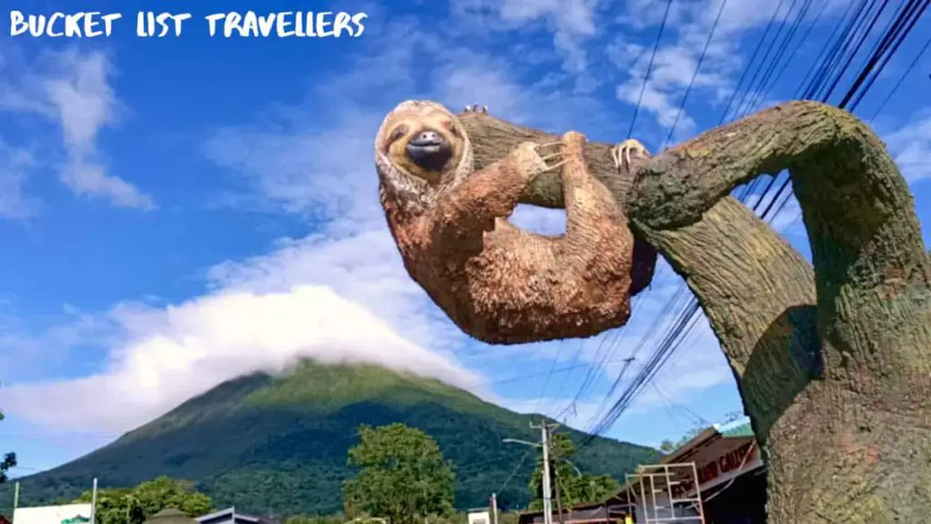 Sloth Statue in front of Volcan Arenal at La Fortuna Costa Rica