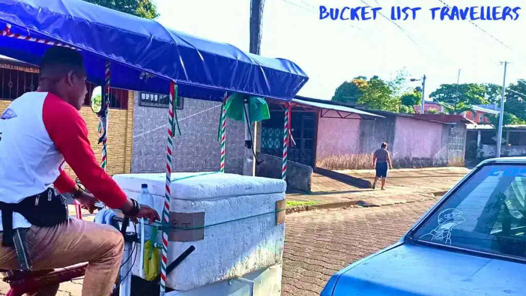 Helado ice cream vendor riding a bike down a street in Managua Nicaragua